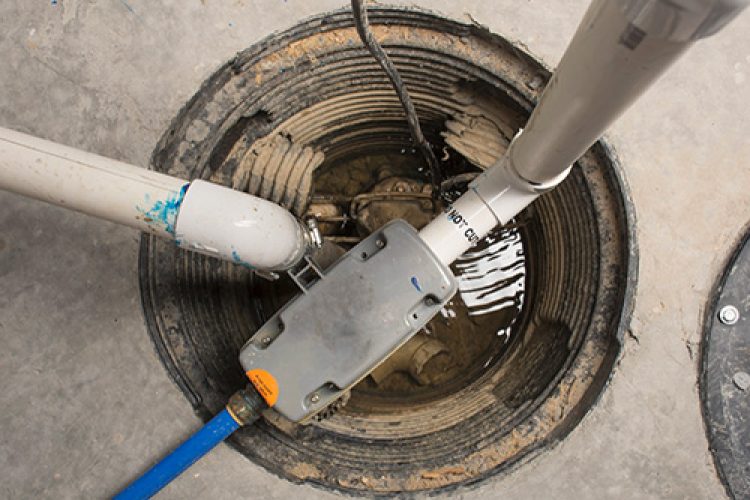 View from above of a newly installed basement sump pump.