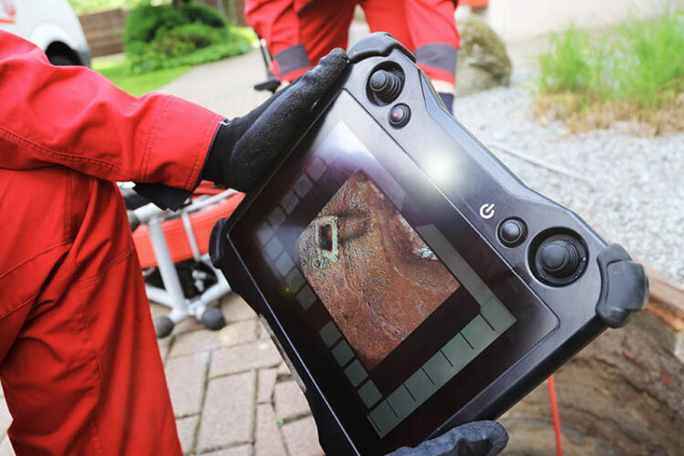 plumber using sewer video camera to inspect pipes.