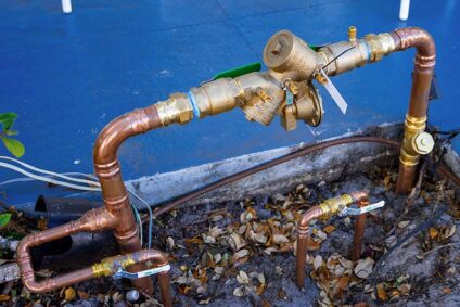 Residential backflow preventer and plumbing pipes.