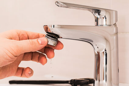Installing aerator on sink faucet.