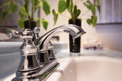 Water dripping from a sink faucet.