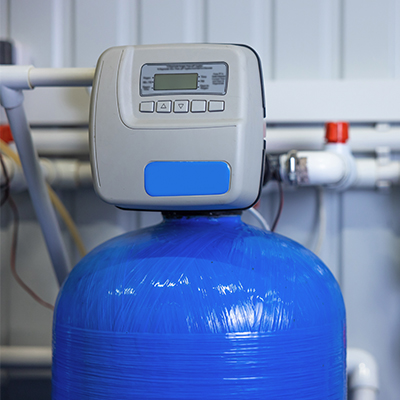 Household water softener with blue tank.