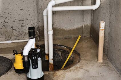 New sump pump and tools sitting next to a sump pit