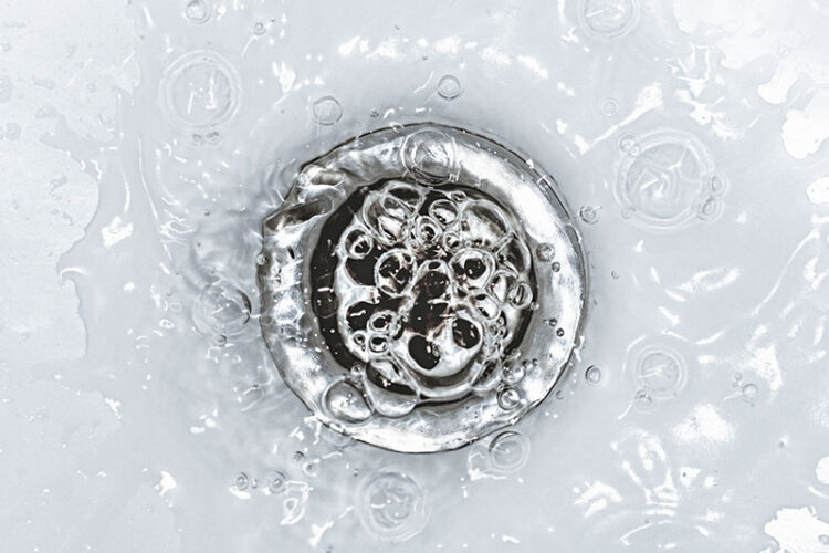 Water backing up in a sink drain.