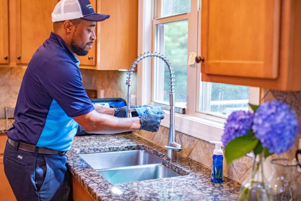 Worker doing work on kitchen sink