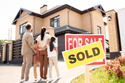 Family looks at home that has just sold