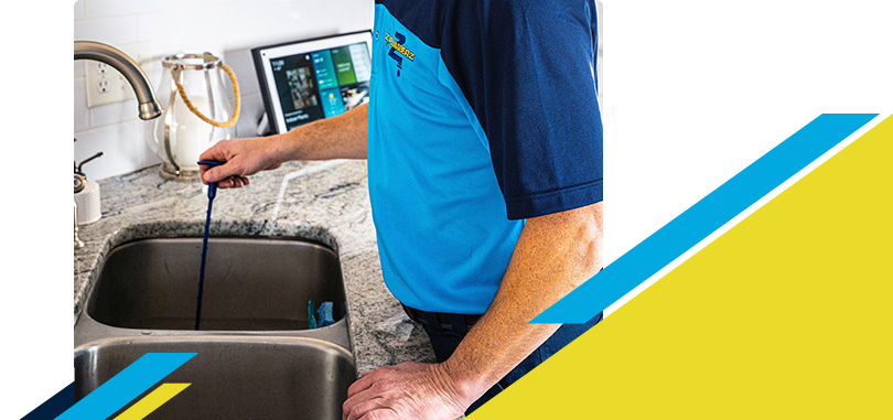 Z PLUMBERZ of Greater Milwaukee technician unclogging drain 