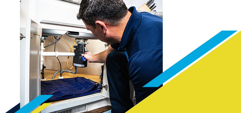 Z PLUMBERZ of Greater Milwaukee technician fixing garbage disposal