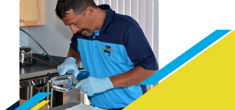 Z PLUMBERZ of Greater Milwaukee technician inspecting sink faucet assembly