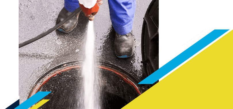 Z PLUMBERZ of Central Long Island technician spraying water down a manhole