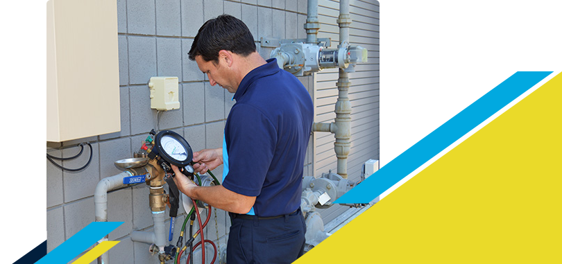 Z PLUMBERZ of Central Long Island technician using a tool to measure backflow