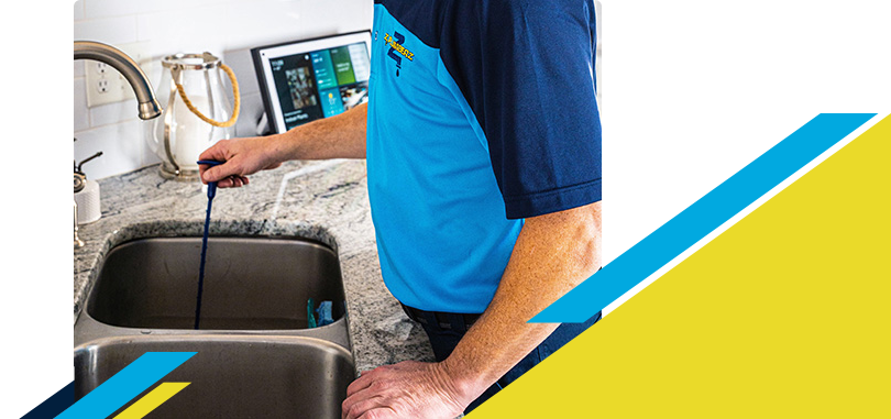 Z PLUMBERZ of Central Long Island technician unclogging drain