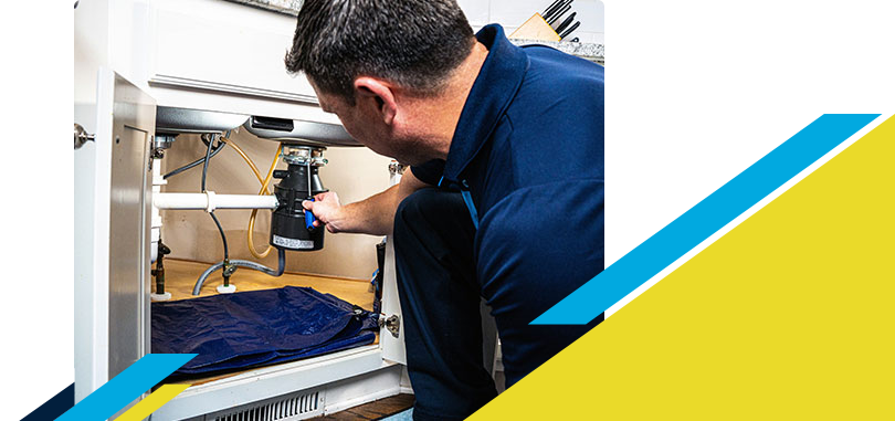 Z PLUMBERZ of Central Long Island technician fixing garbage disposal